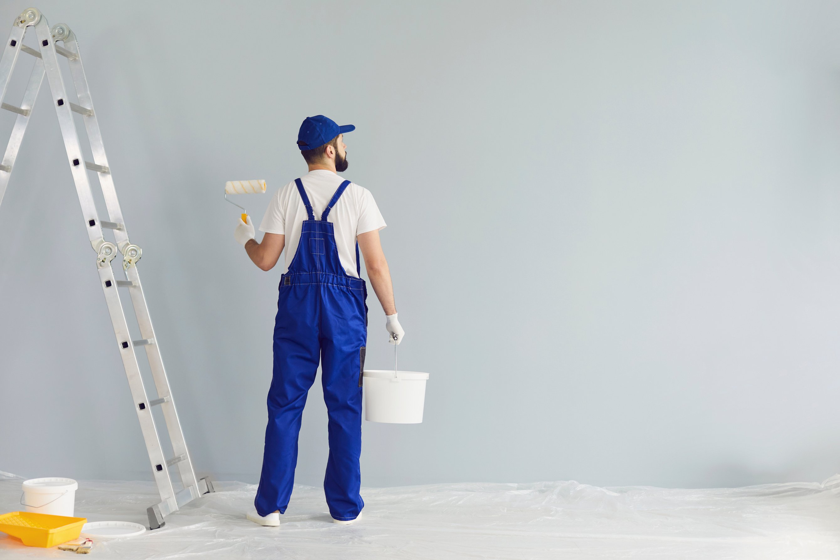 Bearded Painter Contractor Preparing to Paint Wall